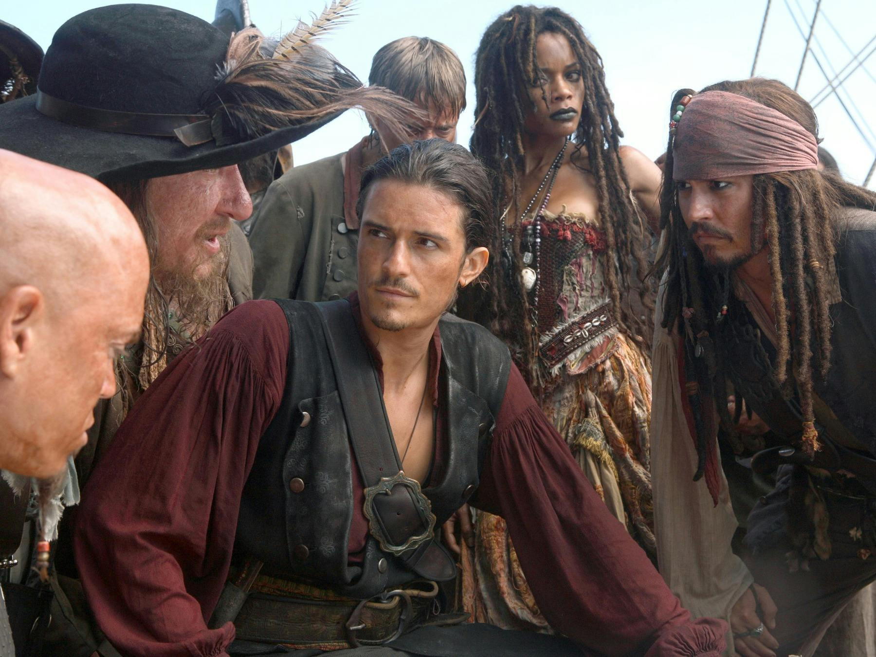 Pirates and others crowded together in deep conversation and listening
