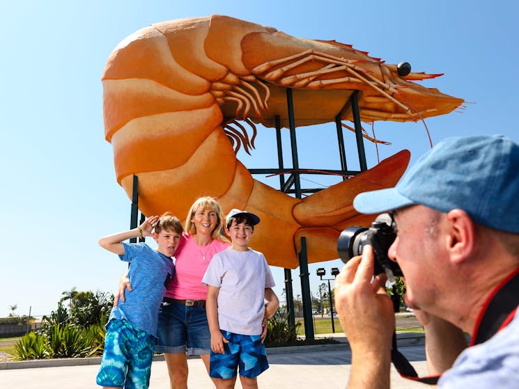 Family taking photos at the Big Prawn