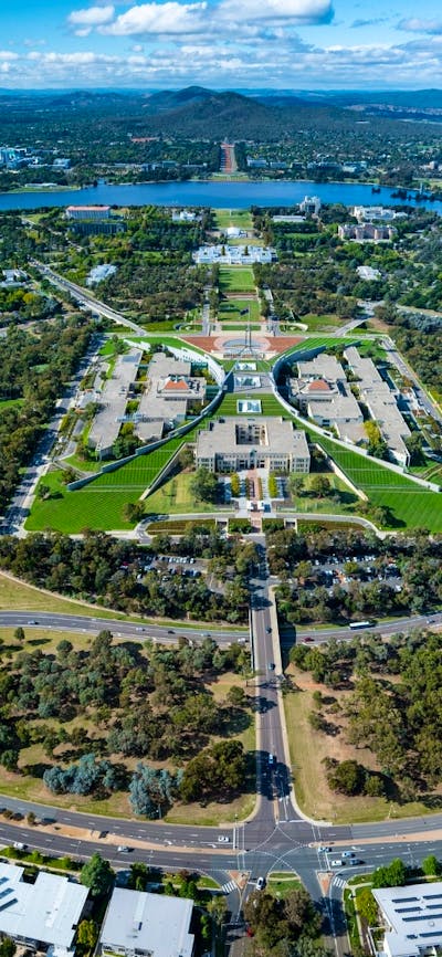 An aerial view shows the capital city with its buildings, streets, and surrounding landscape.