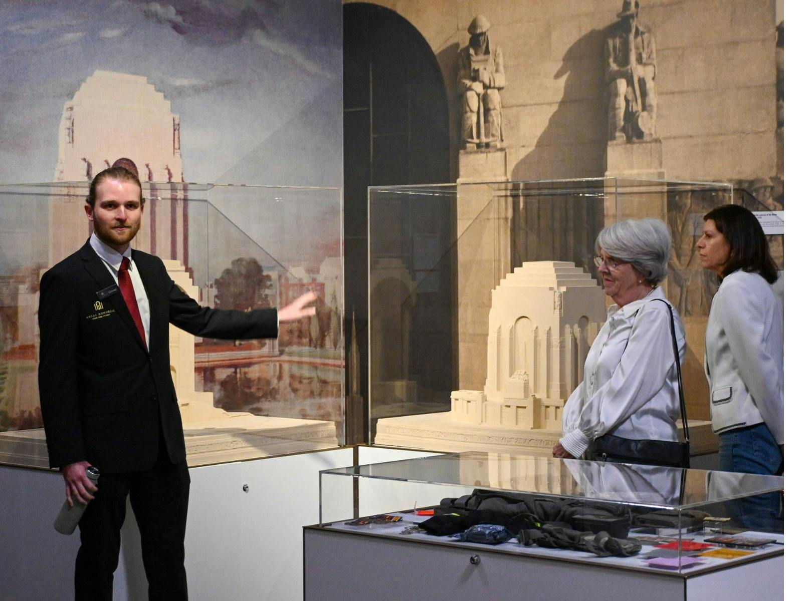 A guide leading a tour with two women.