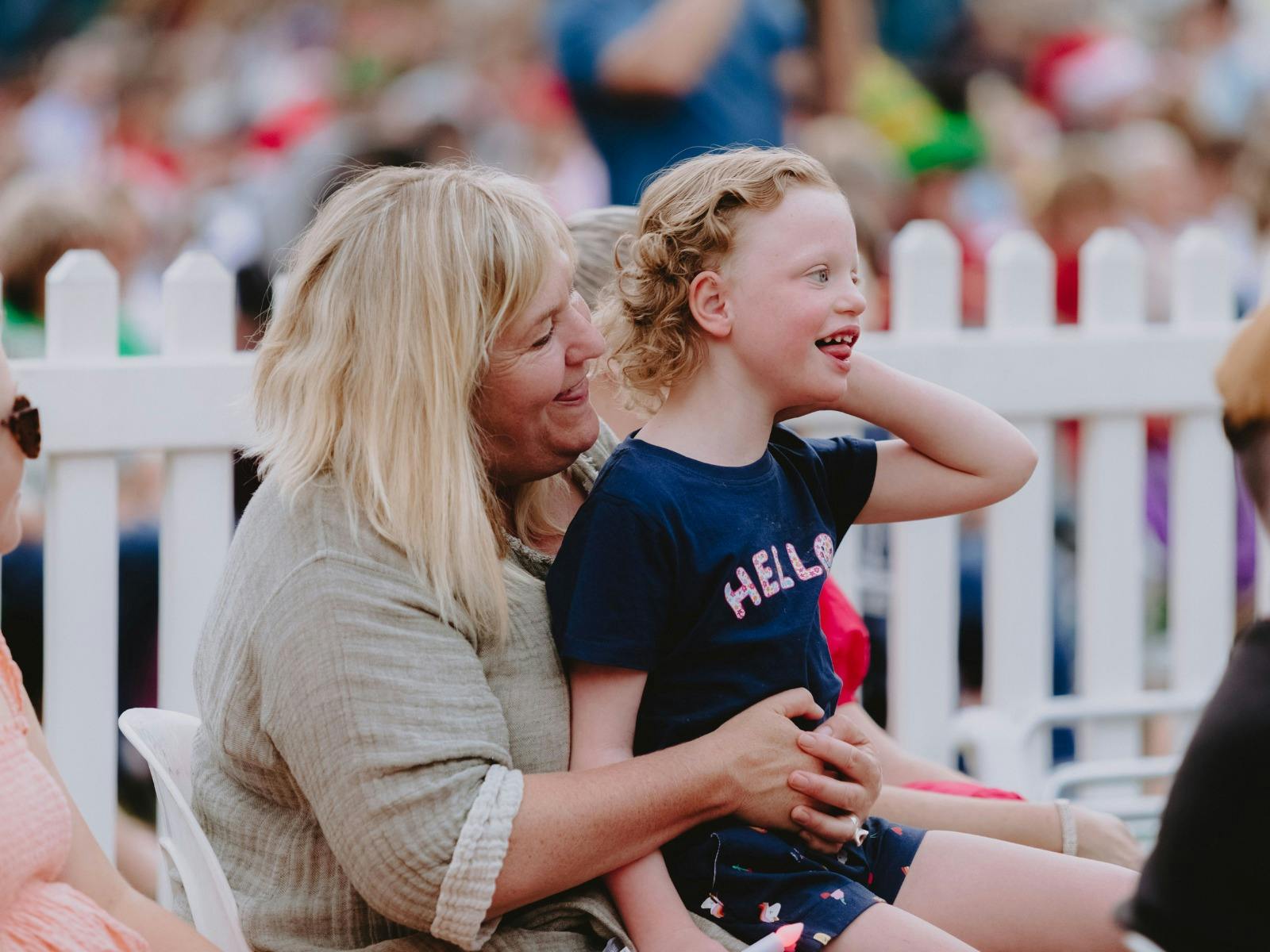 Young child with his mum in the crowd.