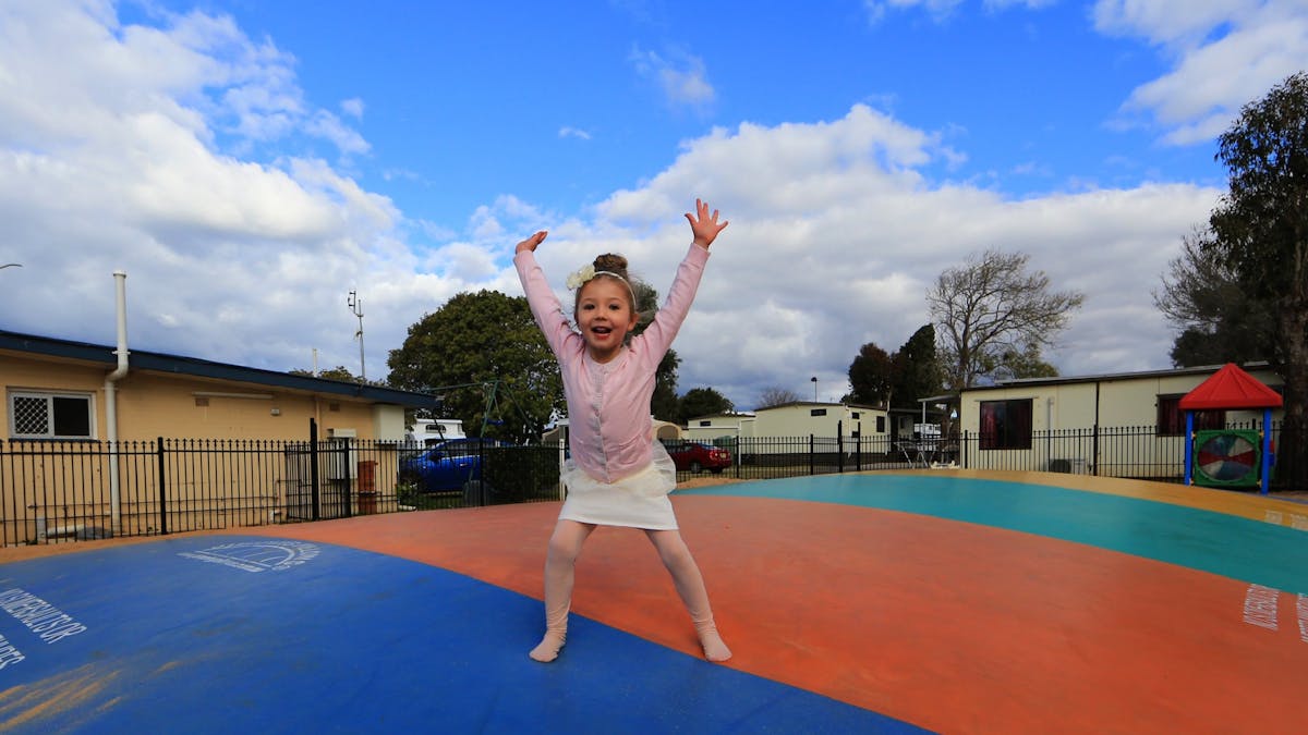 Girl having fun on jumping pillow at BIG4 Toowoomba Garden City Holiday Park