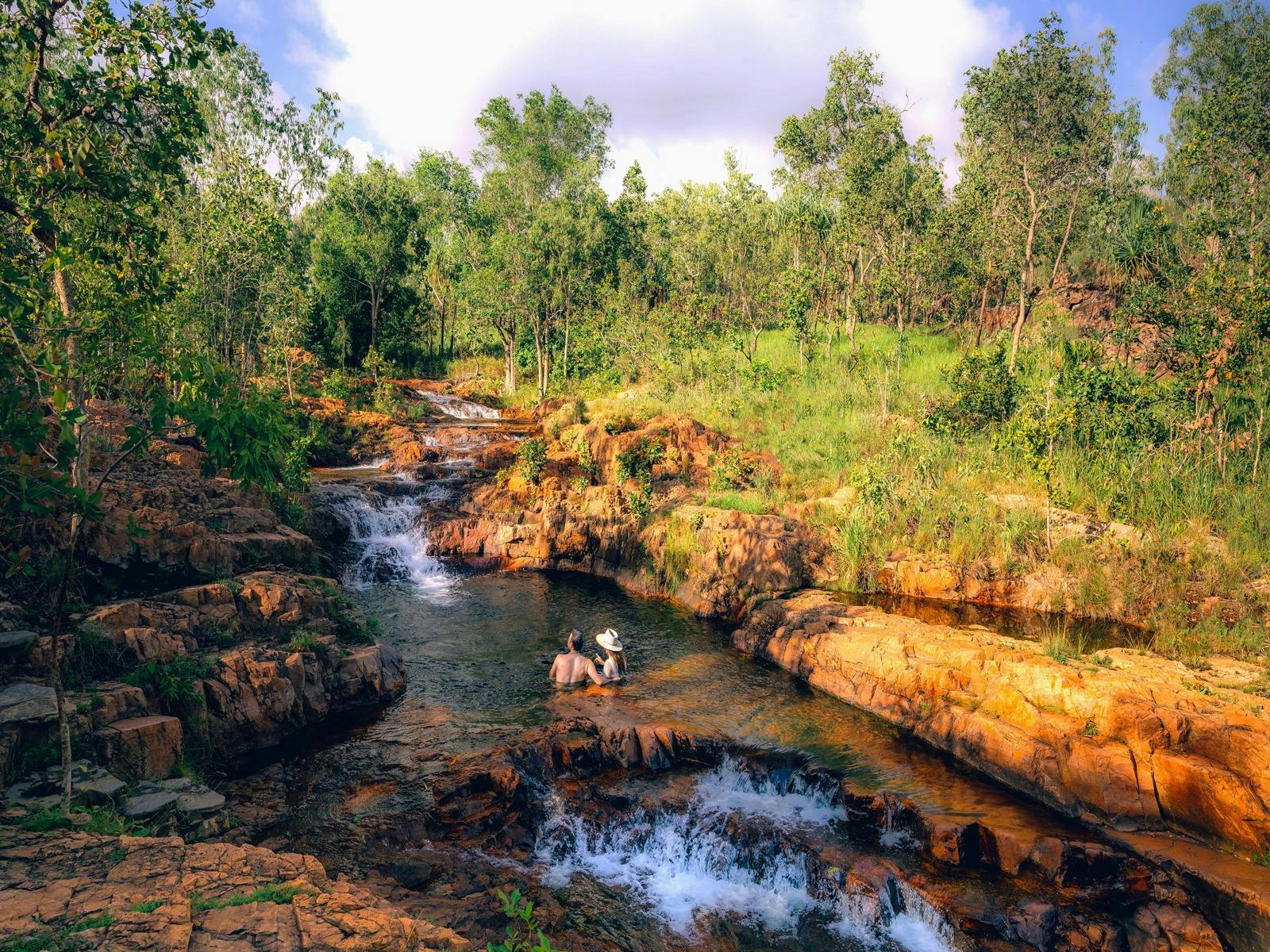 A couple sitting in Buley Rockhole, Litchfieldd