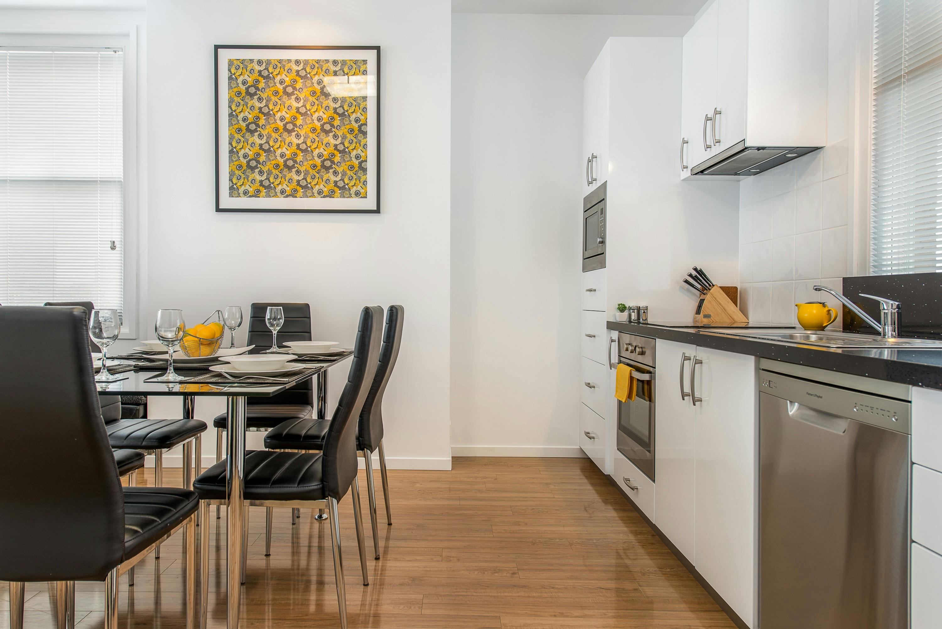 The apartment's fully equipped kitchen with full size appliances and dining table seating six