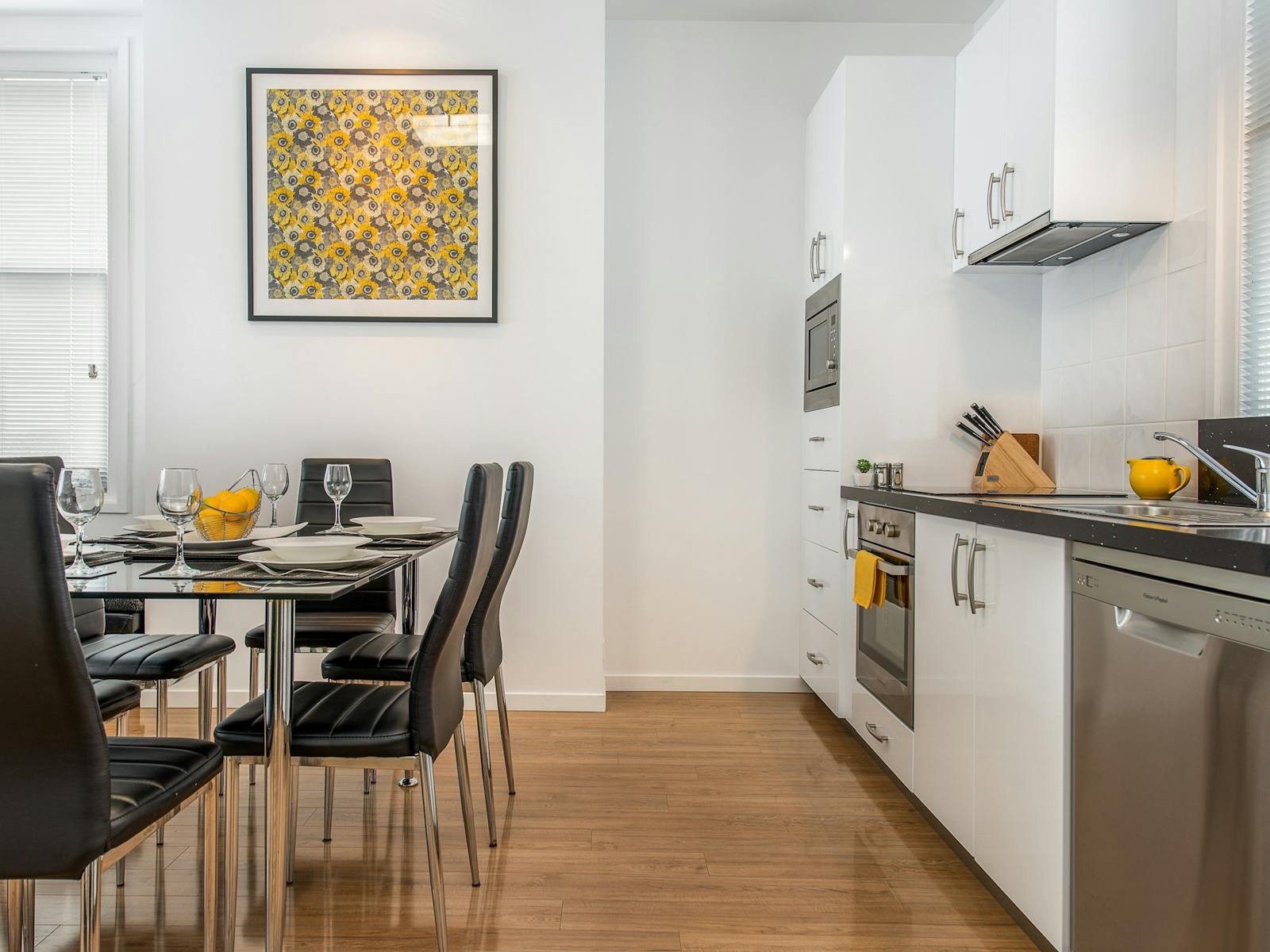 The apartment's fully equipped kitchen with full size appliances and dining table seating six