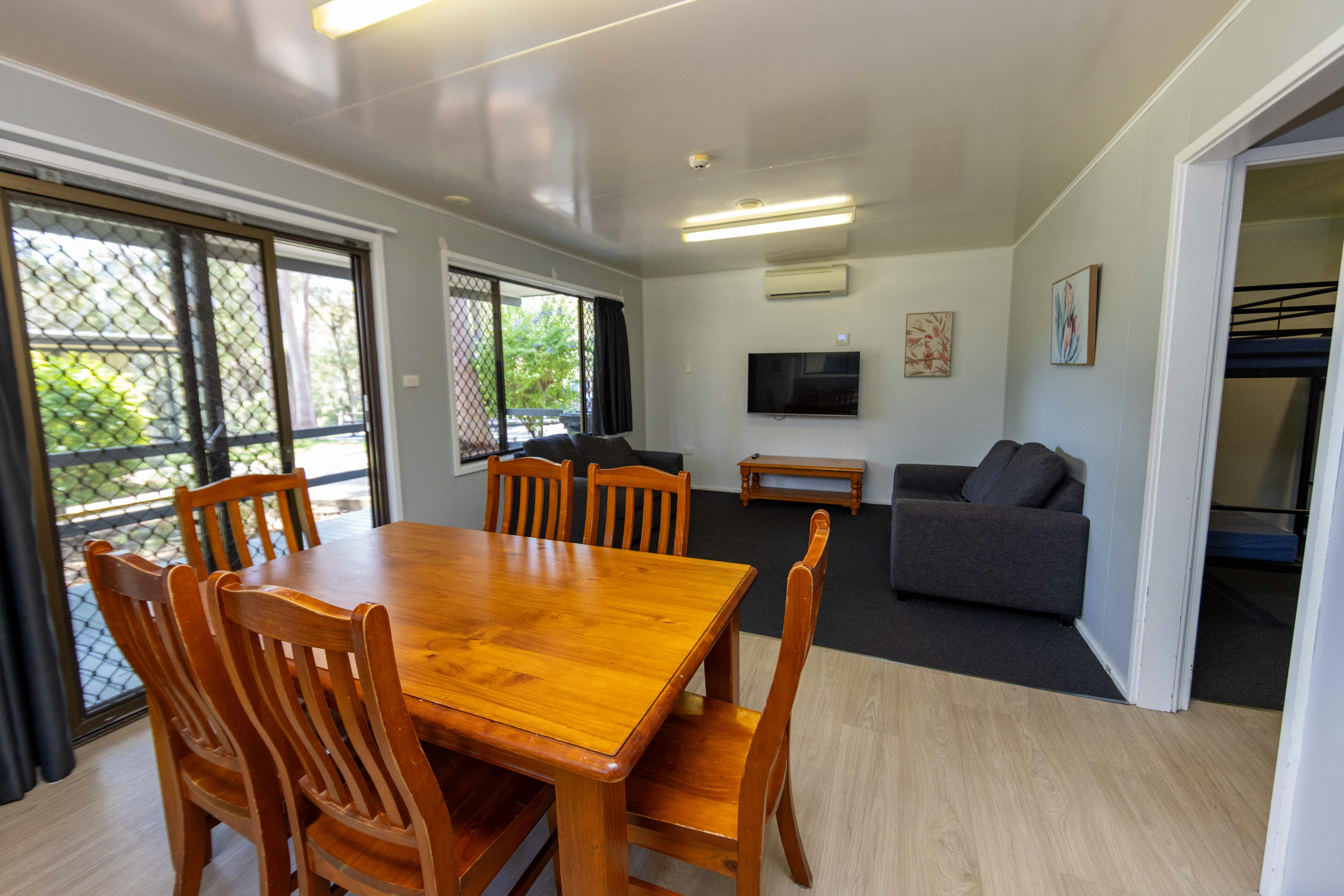 Living room with dining table, couches and TV