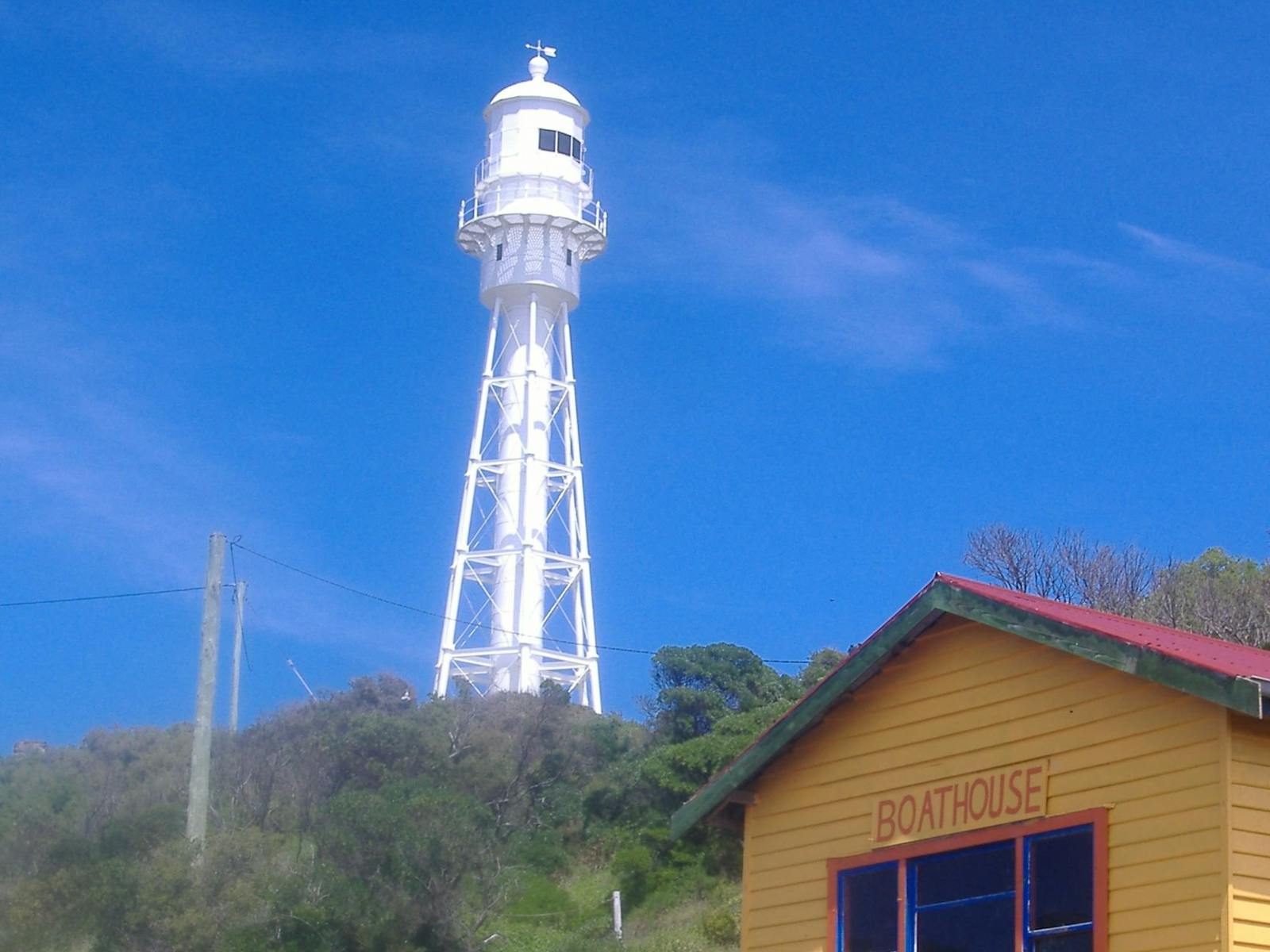Photo of Currie Lighthouse with the boathouse in the foreground