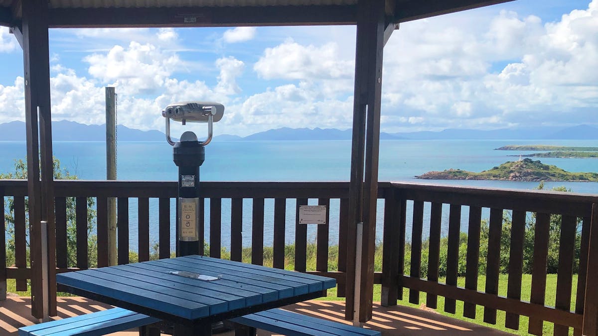 Viewing binoculars for elevated lookout, picnic table in covered area