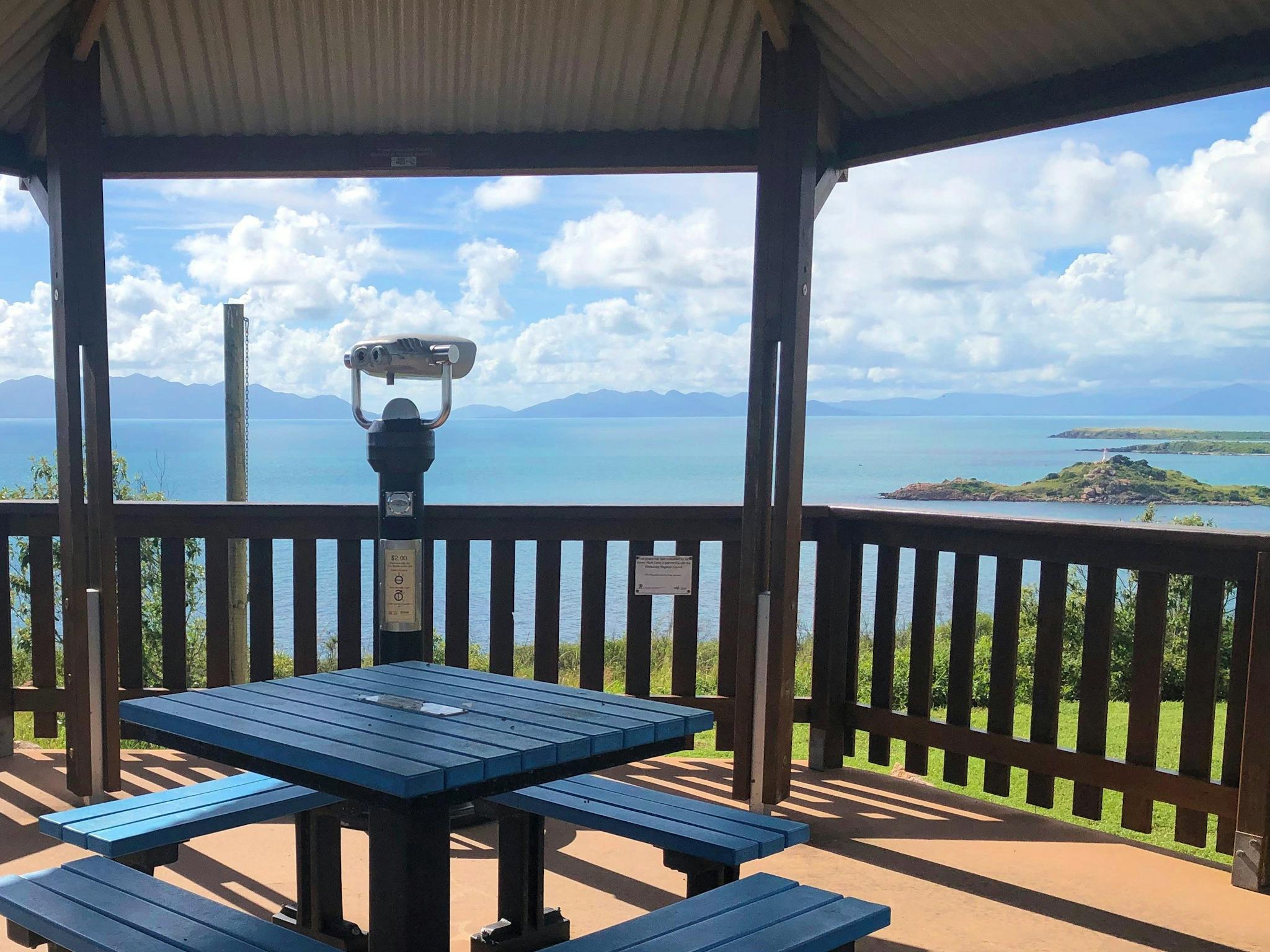 Viewing binoculars for elevated lookout, picnic table in covered area