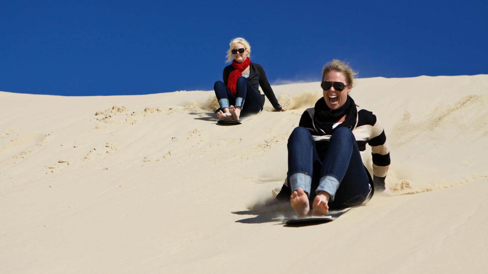 Sandboarding on the dunes at Port Stephens