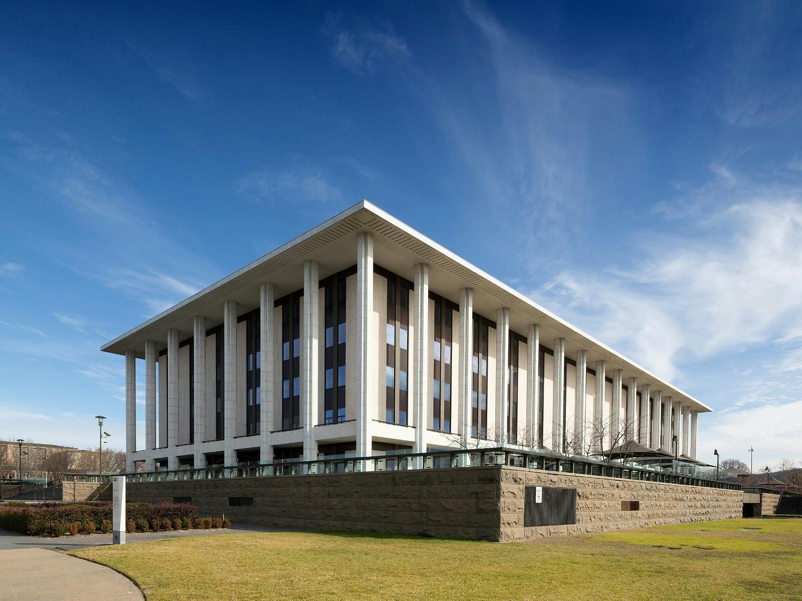 A heritage building, stairs and lawn