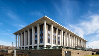 A heritage building, stairs and lawn