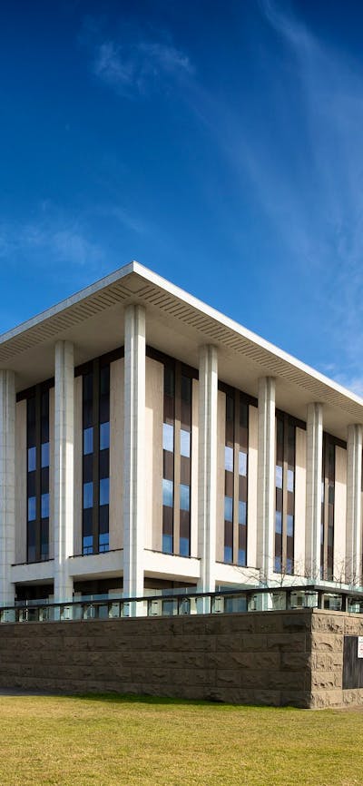 A heritage building, stairs and lawn