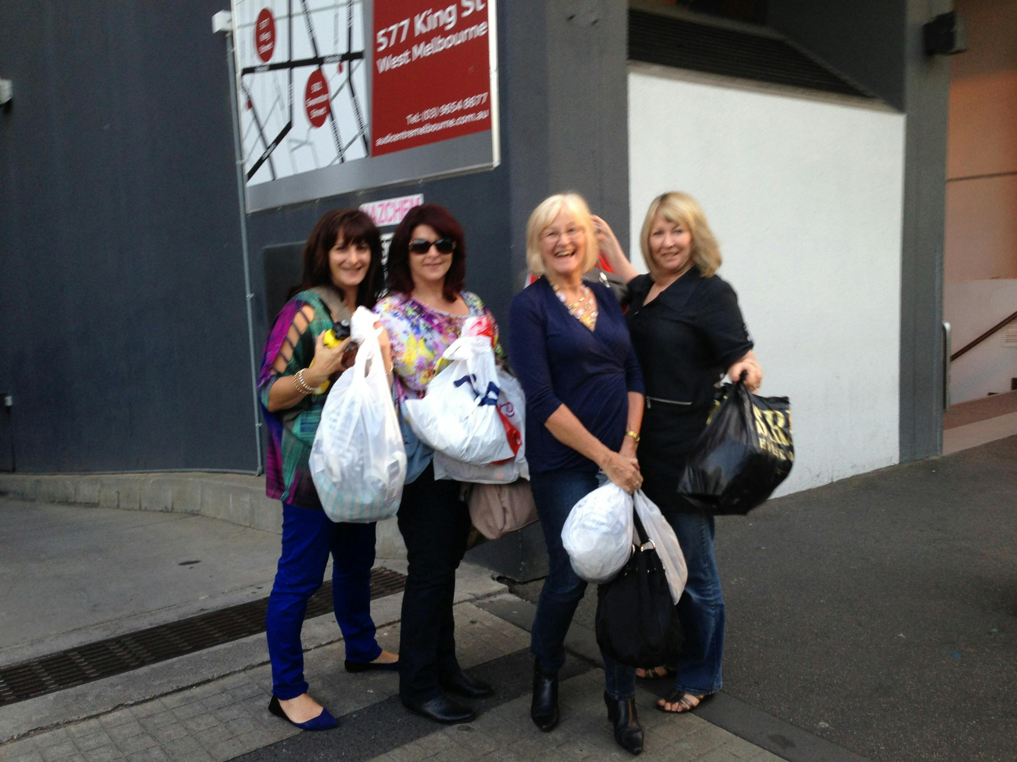 A group of women holding shopping bags