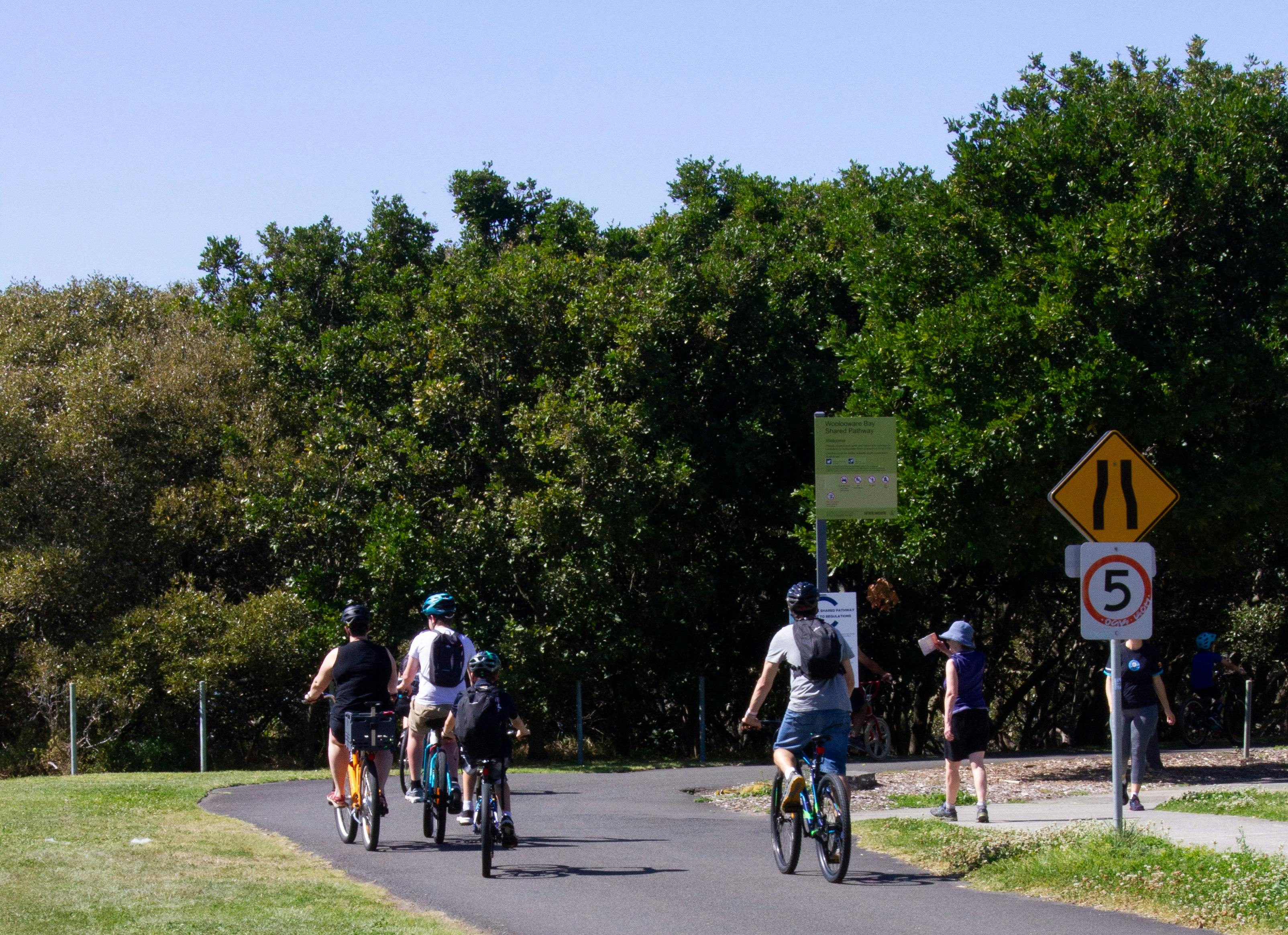 Bike riders riding along a path