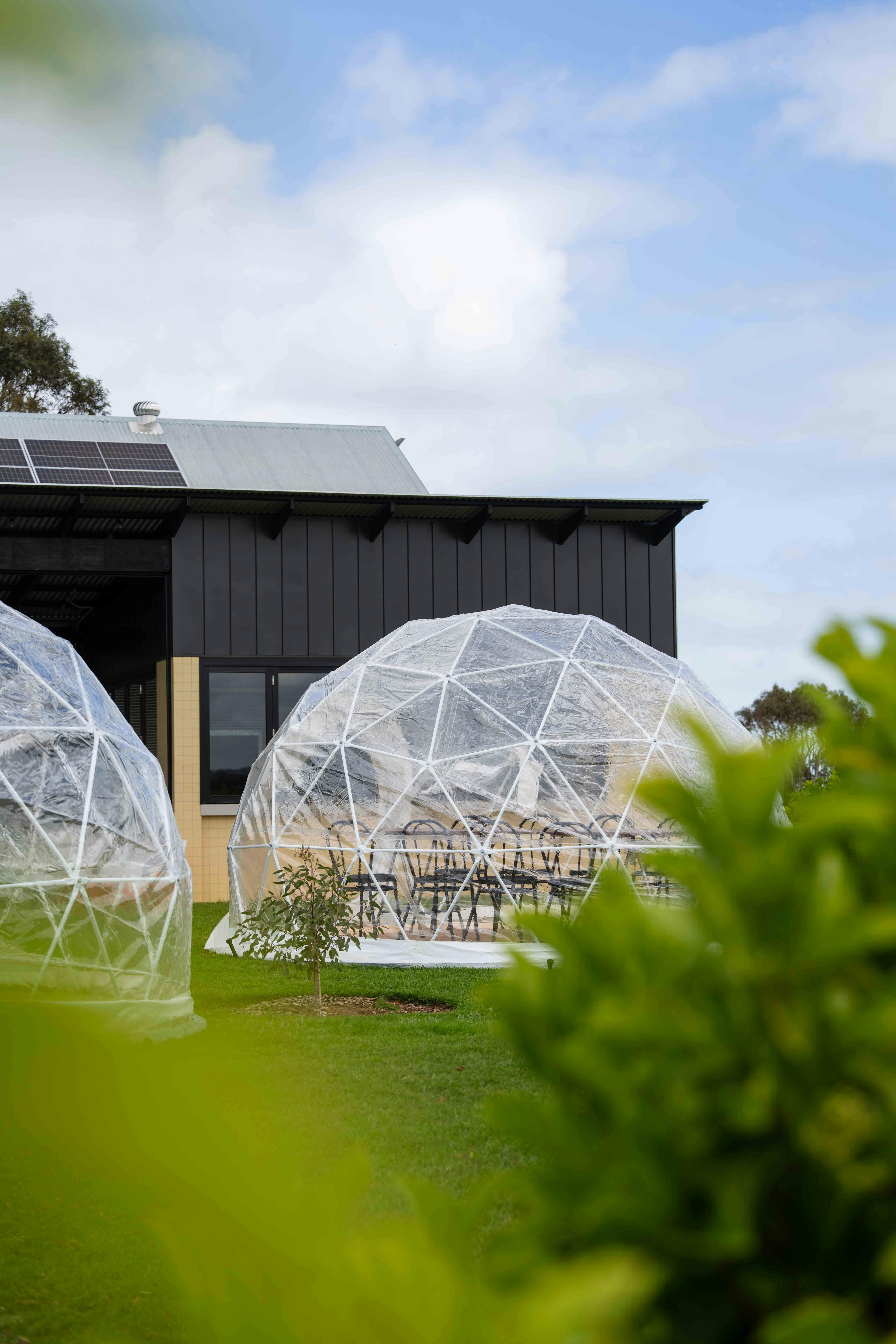 Juniper dome with table inside and never never distillery in background