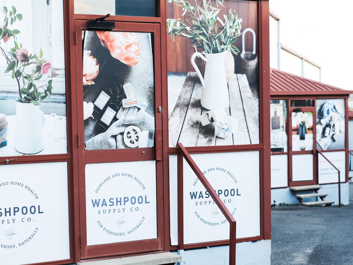 Image of the drive up to the Washpool entrance, displaying imagery on the building of  products.