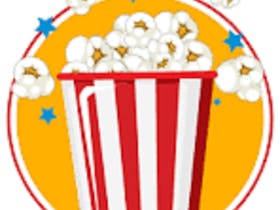 A red and white vertical striped box full of white popcorn falling out of the box.