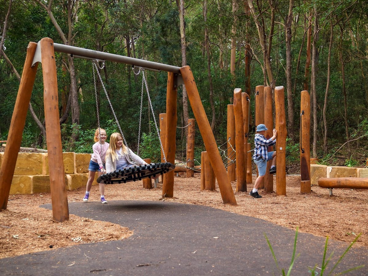 Children playing on swing and play equipment Children playing on swing and play equipment