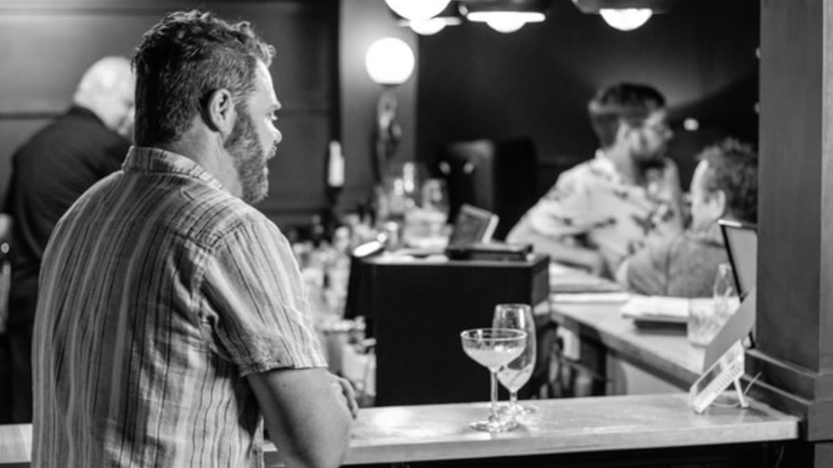 A gentleman enjoying a quiet beer at the bar