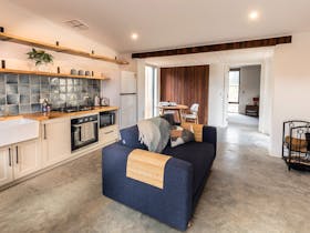 Open plan living area with kitchen, lounge and dining