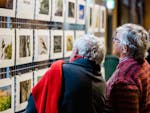 Two women looking at the photographs