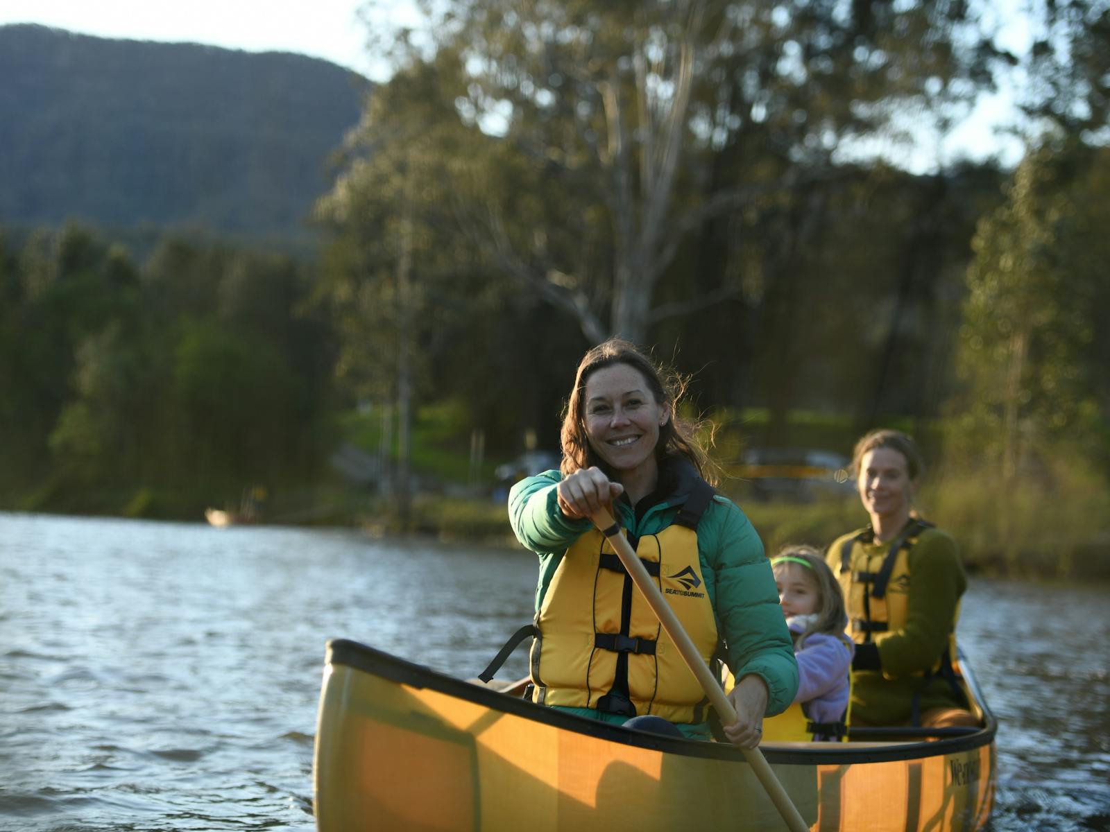 2 women and a girl in a canoe