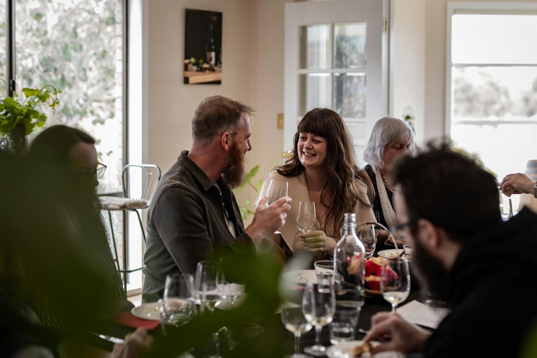 couple enjoying wine and food as part of a small wine tasting event