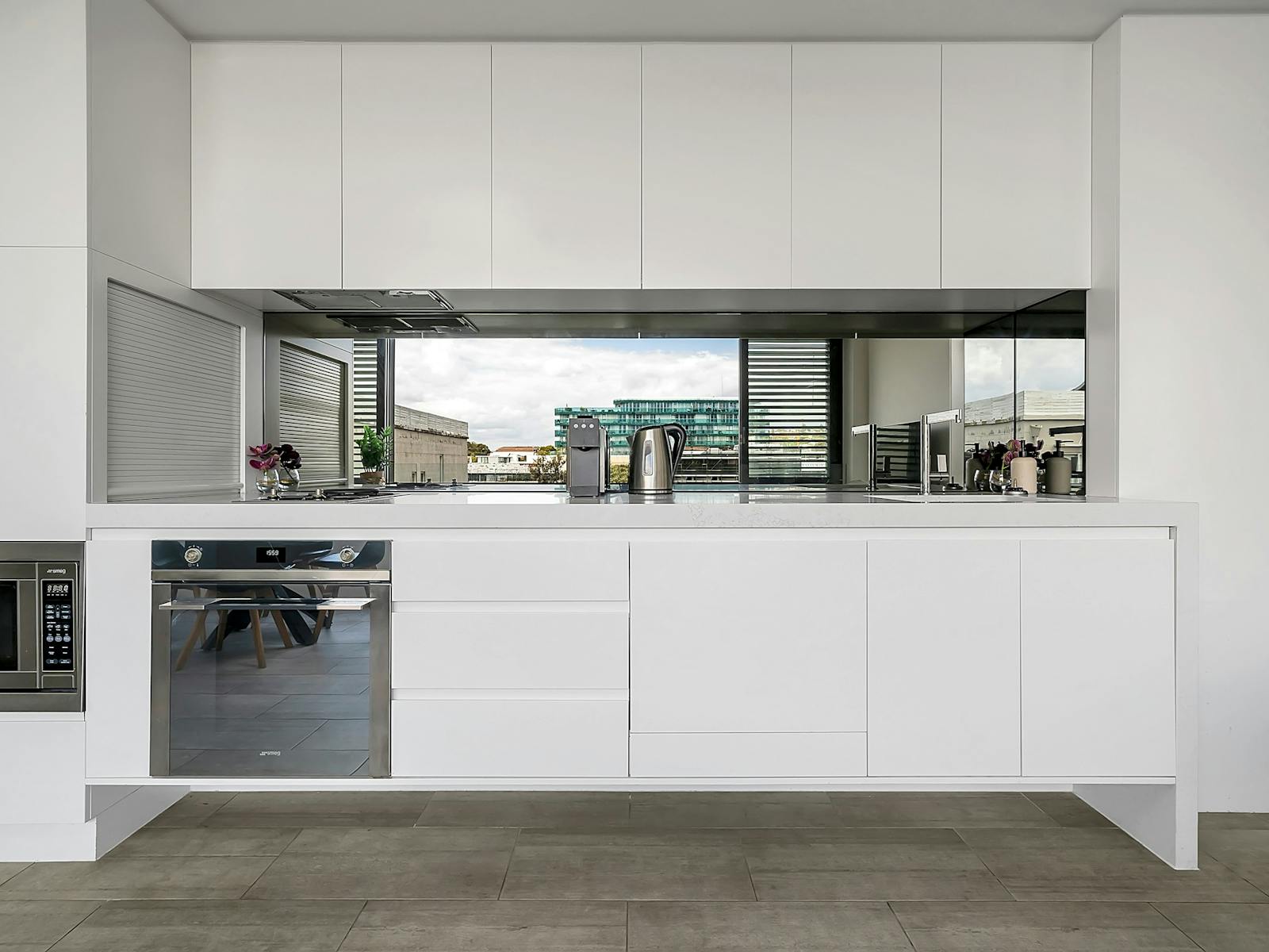 Fully equipped kitchen with sleek cabinetry and stainless appliances.