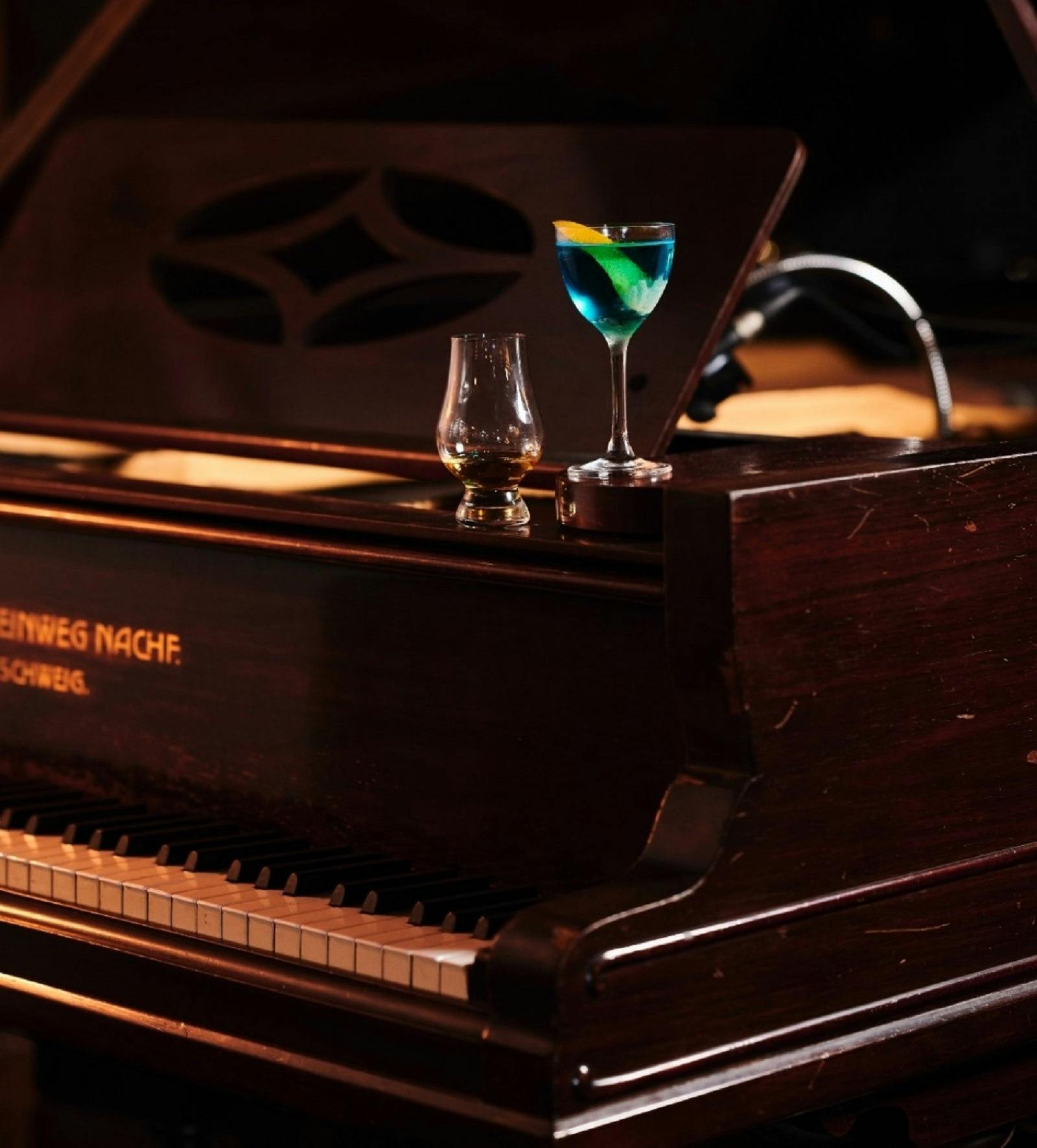 Cocktails sitting on top a piano
