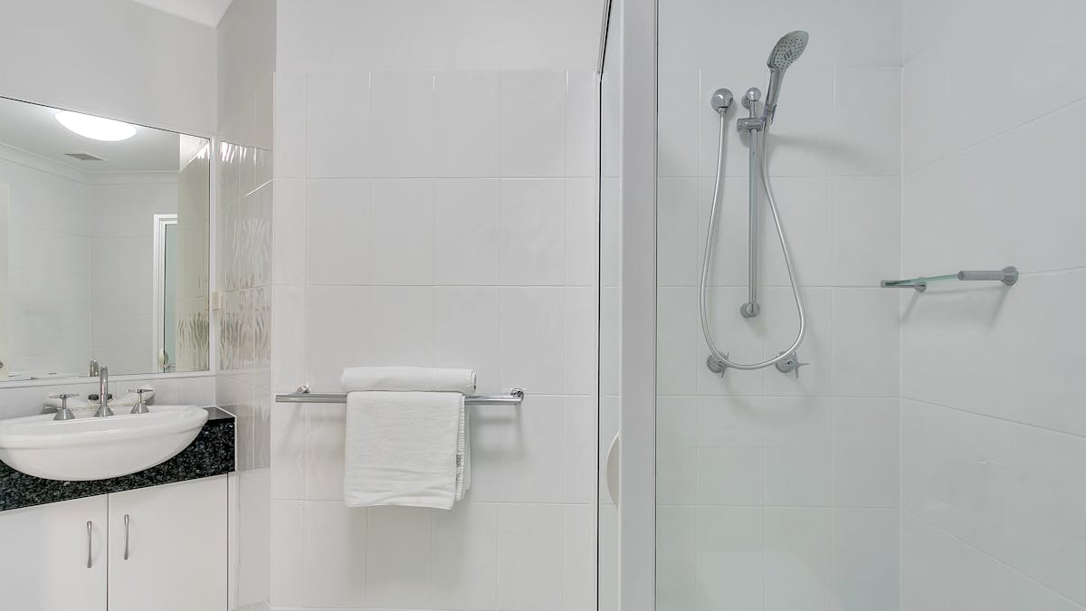 Well appointed large bathroom with shower and toiletries.