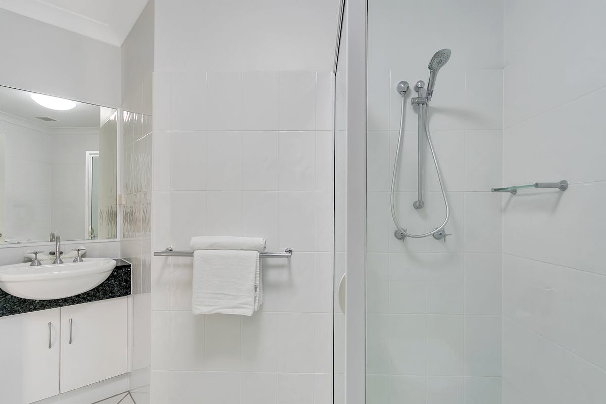 Well appointed large bathroom with shower and toiletries.