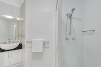 Well appointed large bathroom with shower and toiletries.