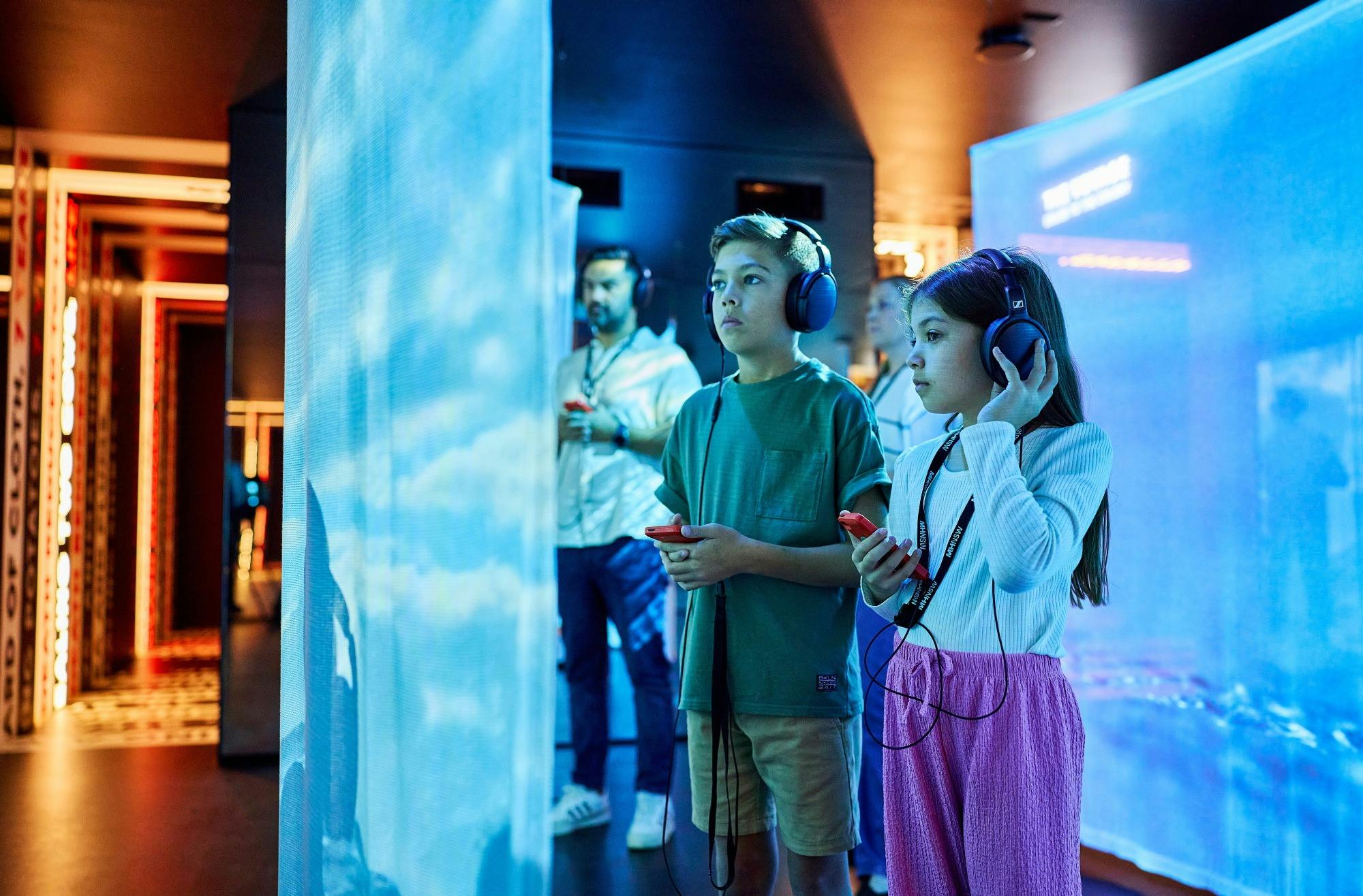 Children wearing head sets at Hyde Park Barracks