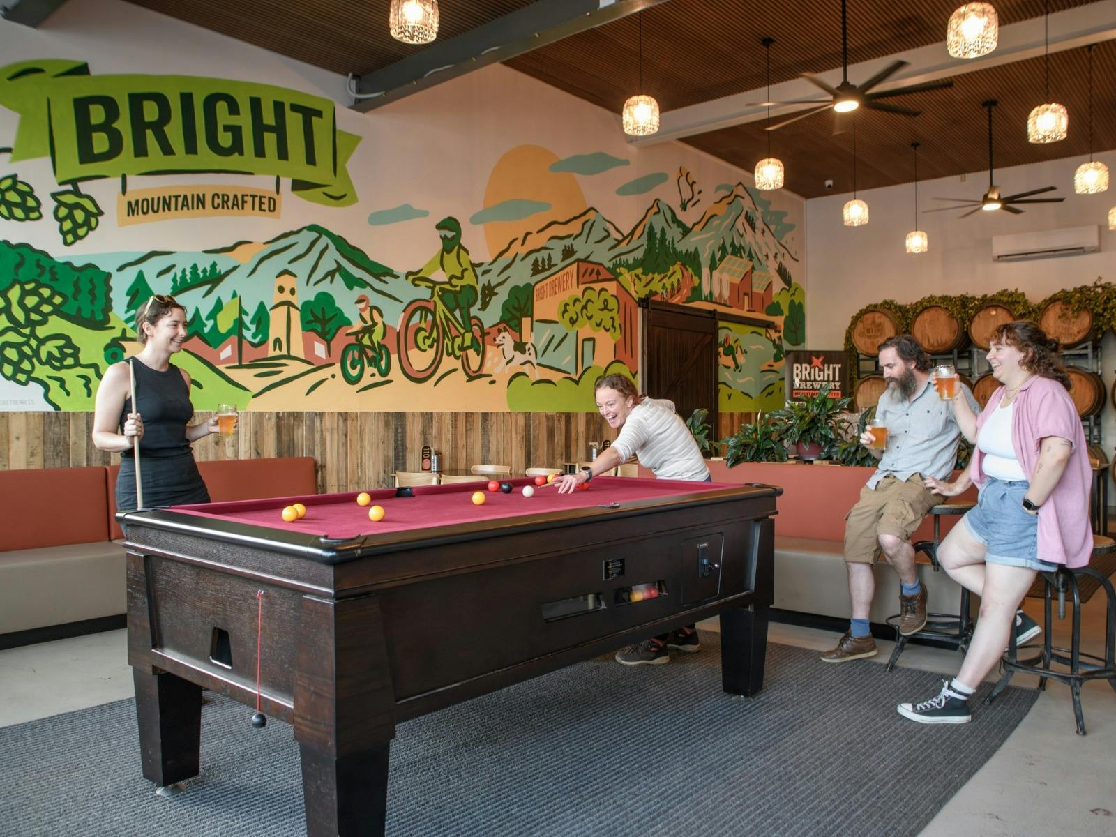 Friends playing a game of pool in the Brewhouse