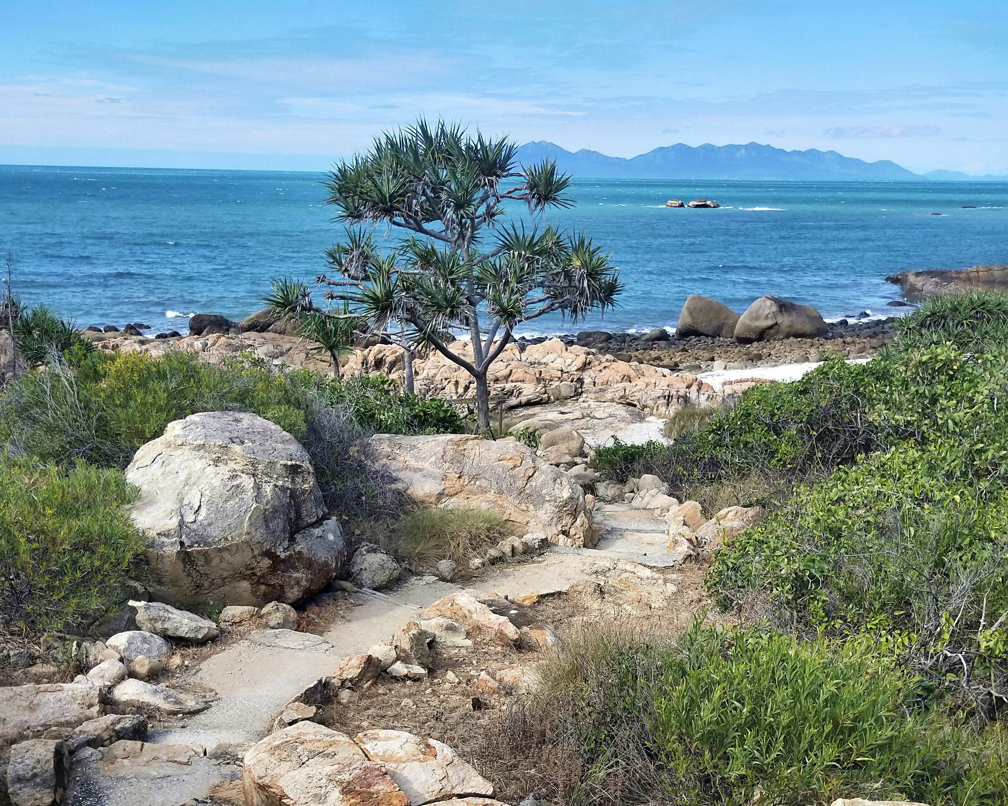 Trail with island view wending down to scenic bay