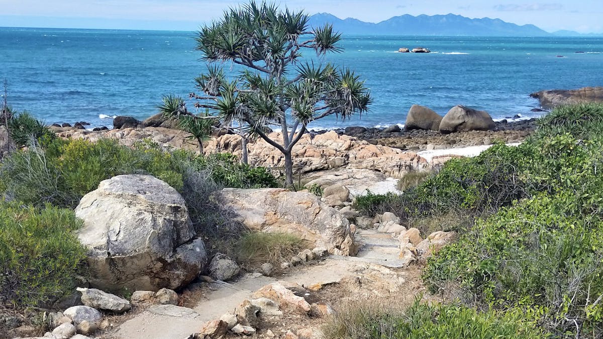 Trail with island view wending down to scenic bay