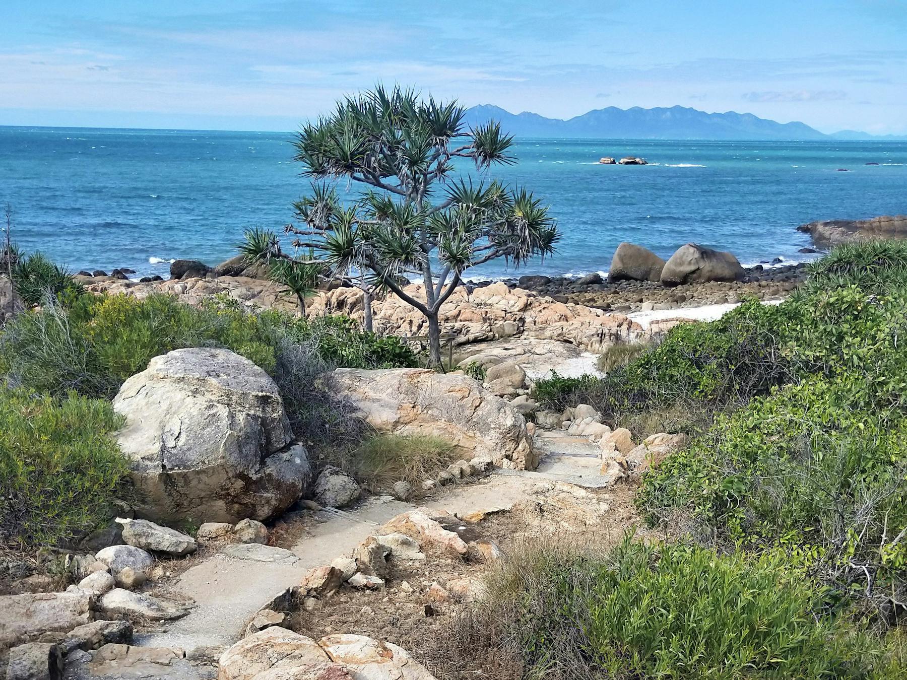 Trail with island view wending down to scenic bay