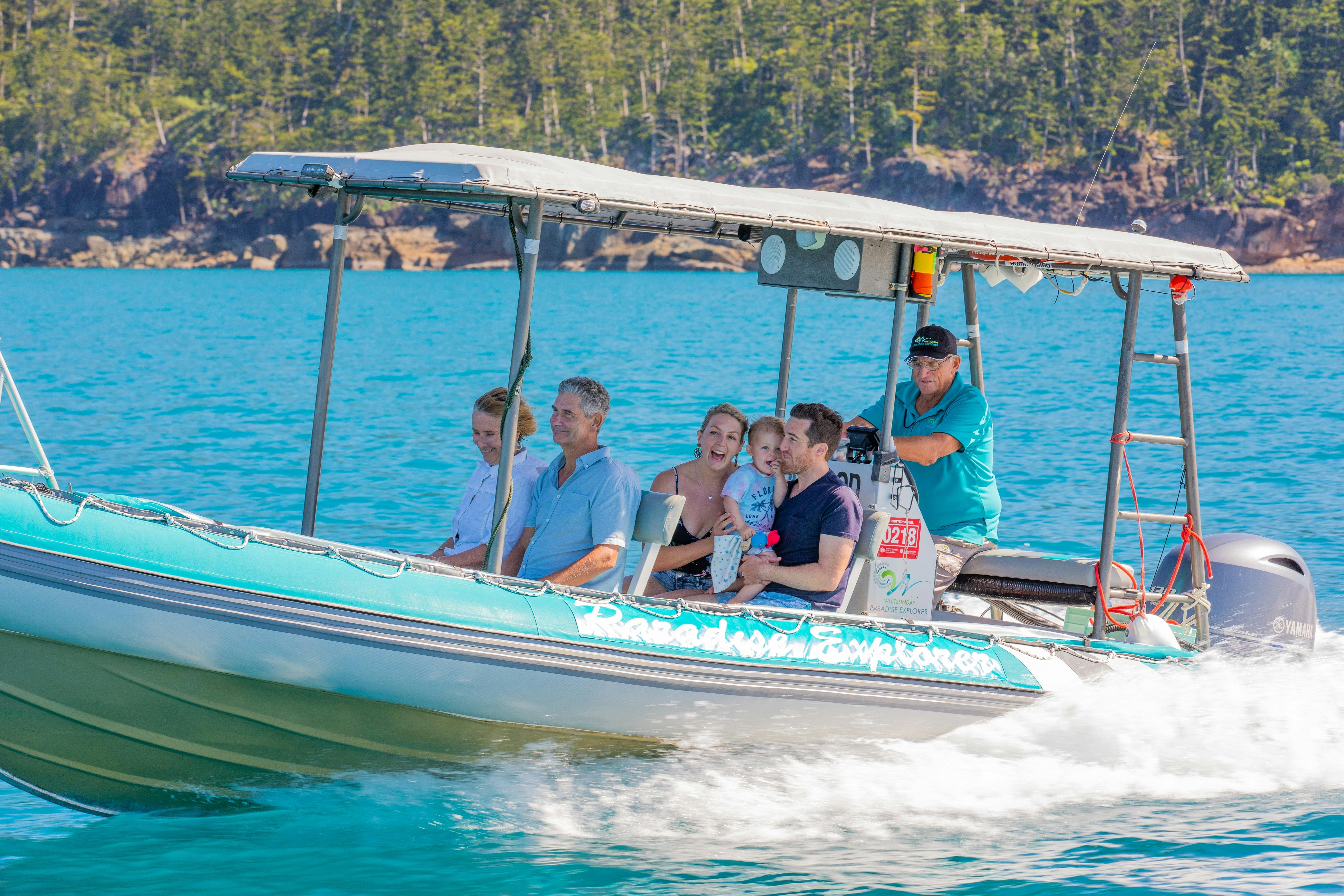 A small group of people enjoying their boat trip along the blue waters