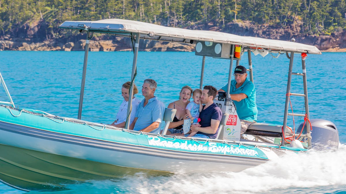 A small group of people enjoying their boat trip along the blue waters