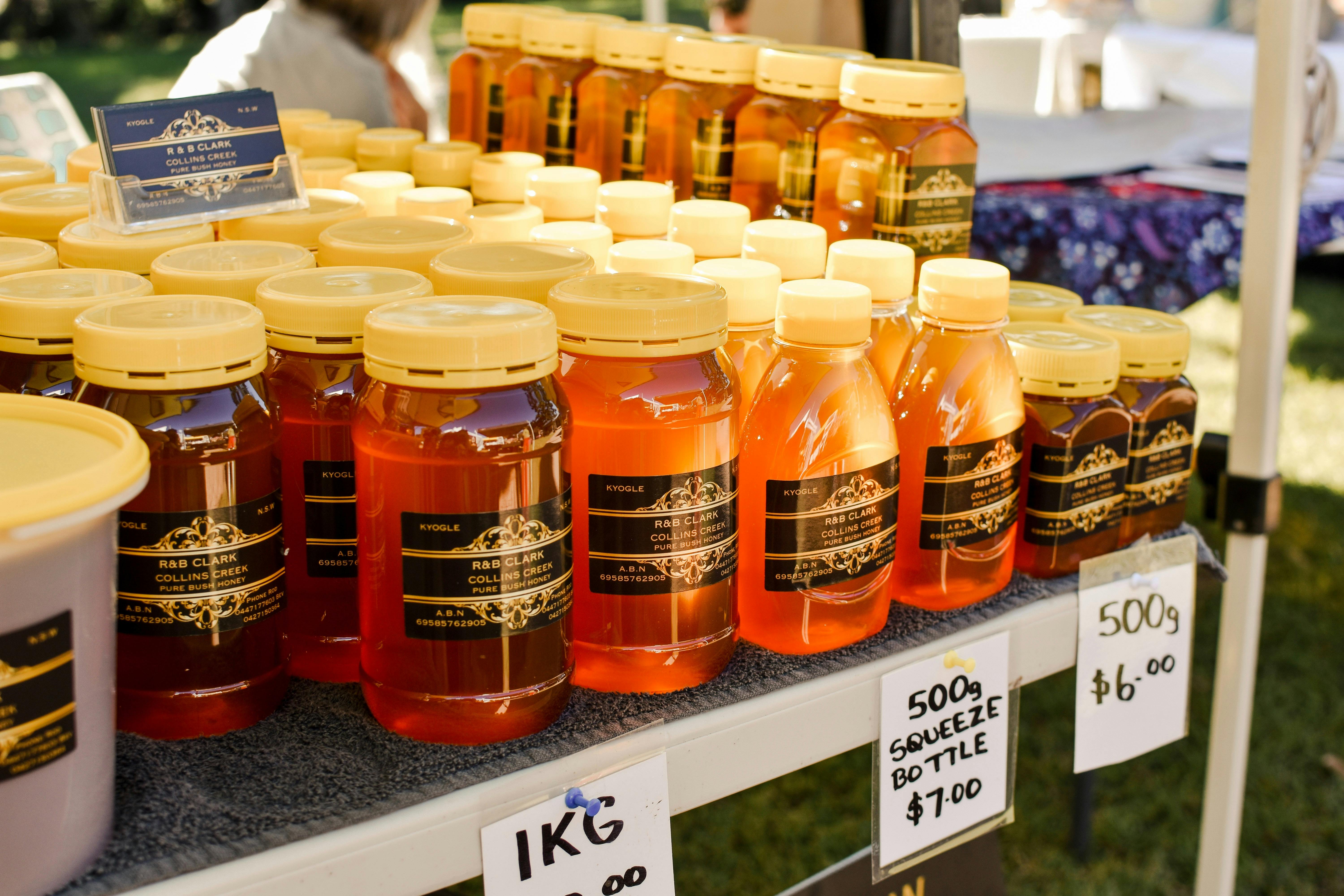 Jars of honey and beeswax products on a table
