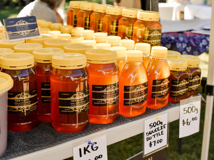 Jars of honey and beeswax products on a table