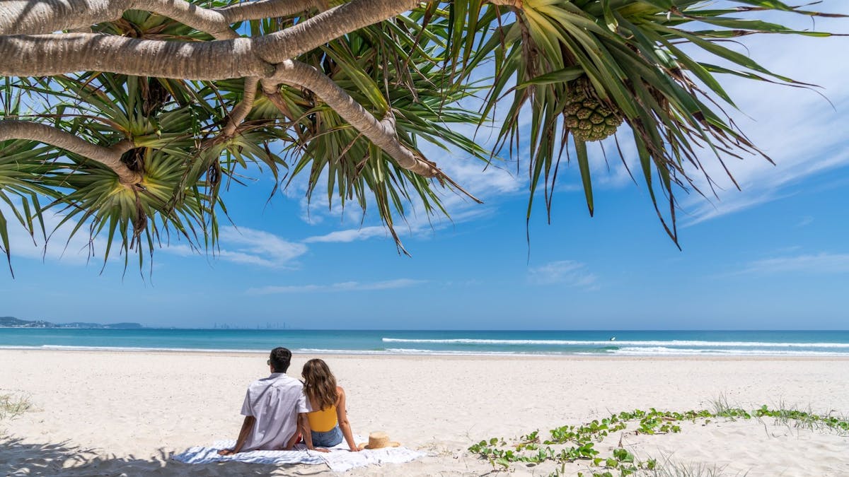 Couple sitting at Kirra Beach