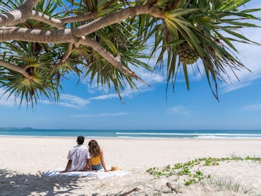 Couple sitting at Kirra Beach Couple sitting at Kirra Beach
