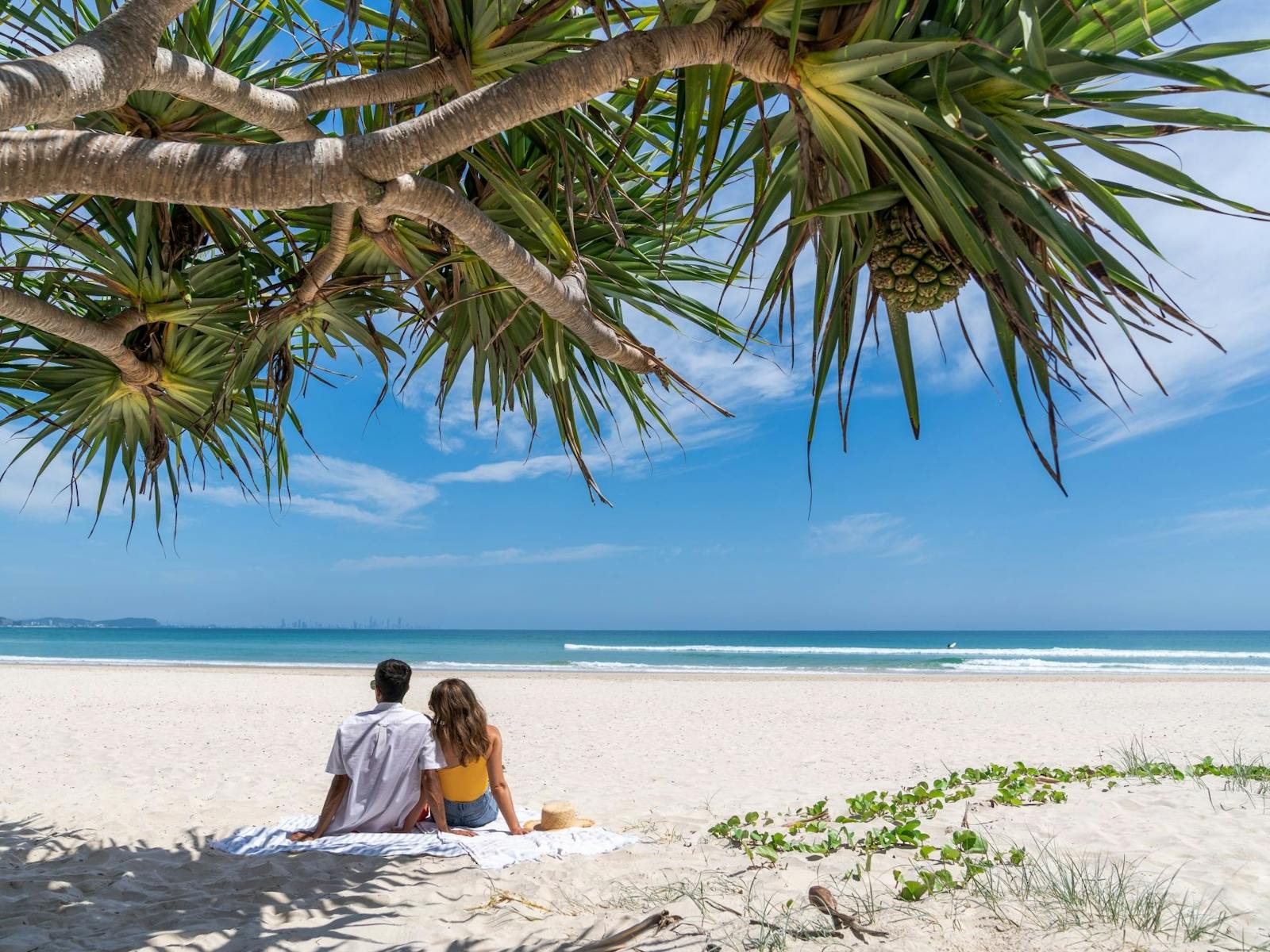 Couple sitting at Kirra Beach Couple sitting at Kirra Beach