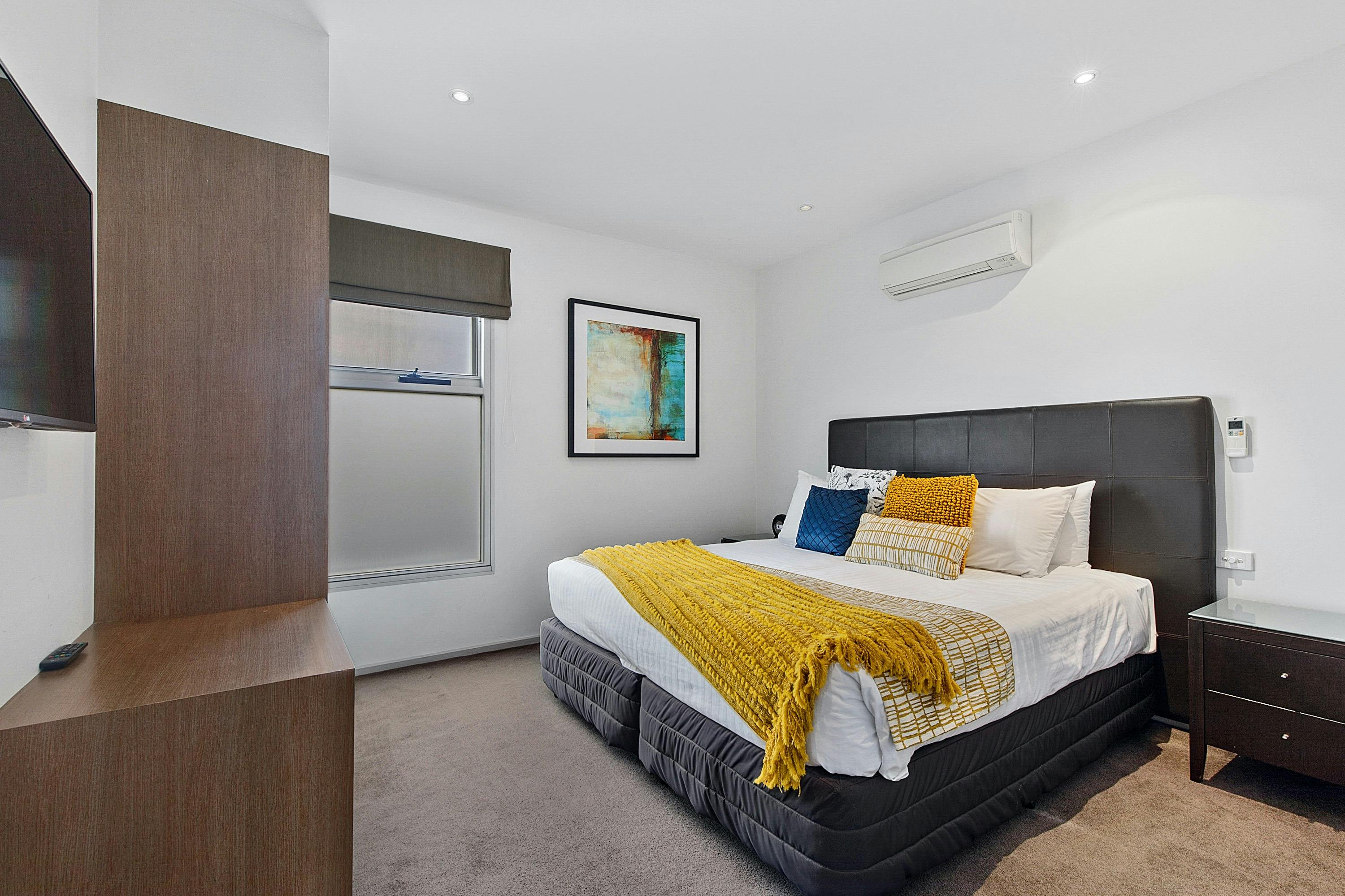 Main Bedroom with wardrobe, LCD television and luxury bedding at The Gateway