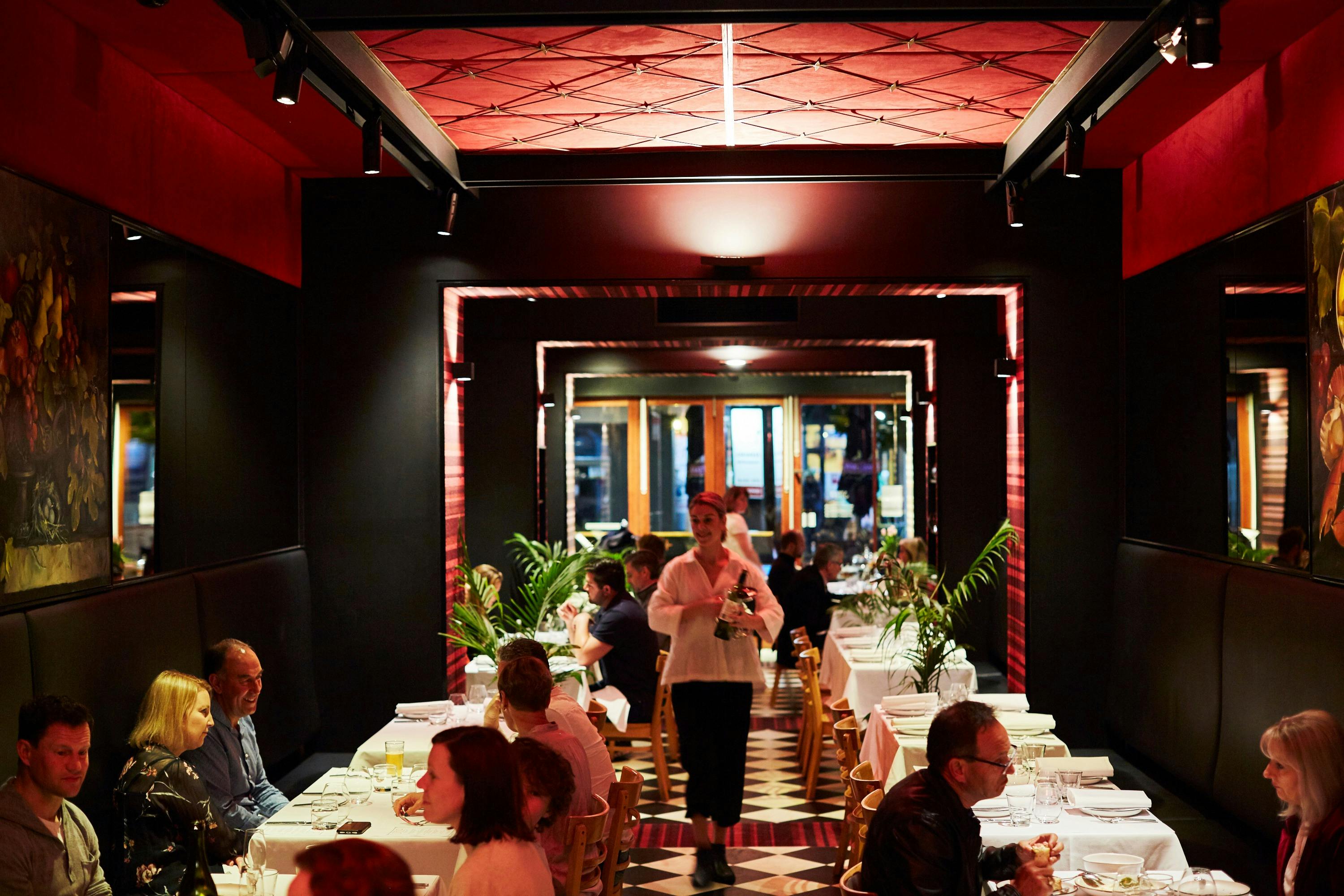 Stelo Dining Hall with diners and waiters