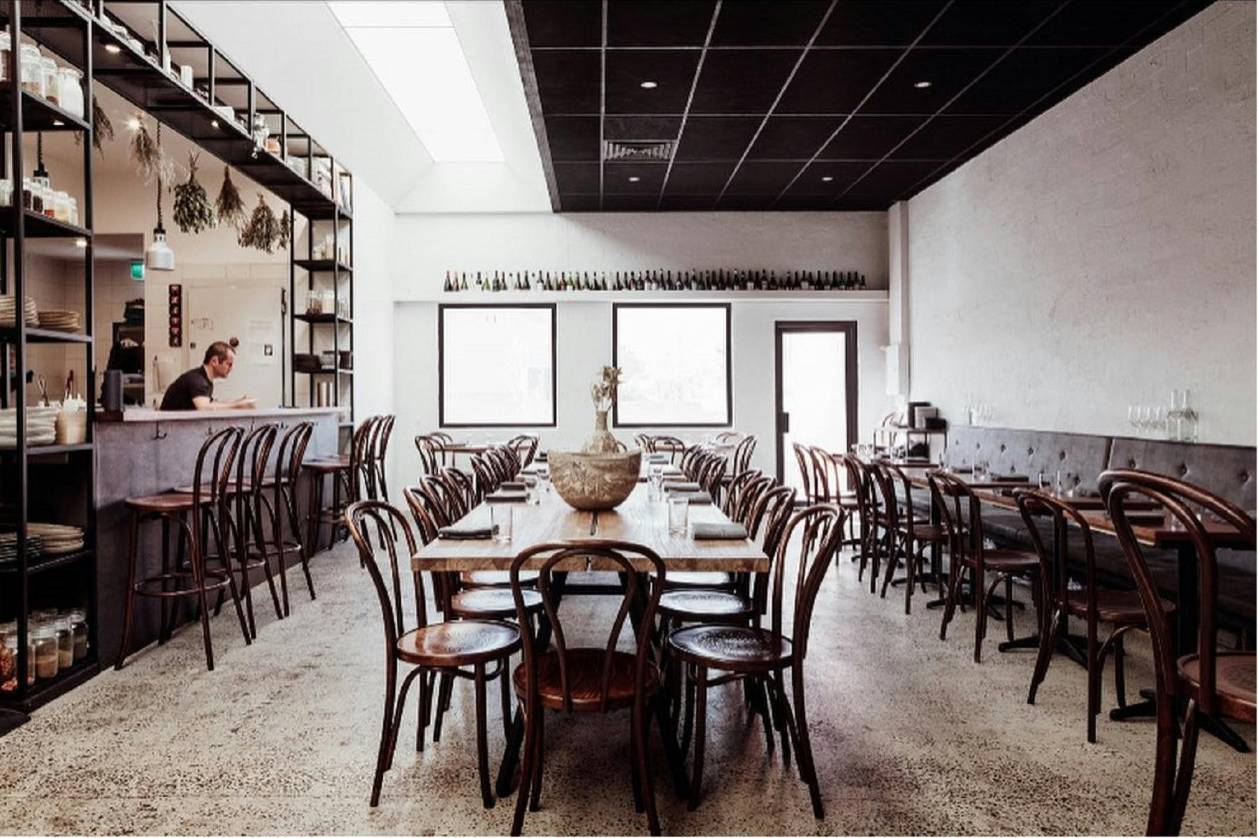 Empty restaurant with tables set ready for service
