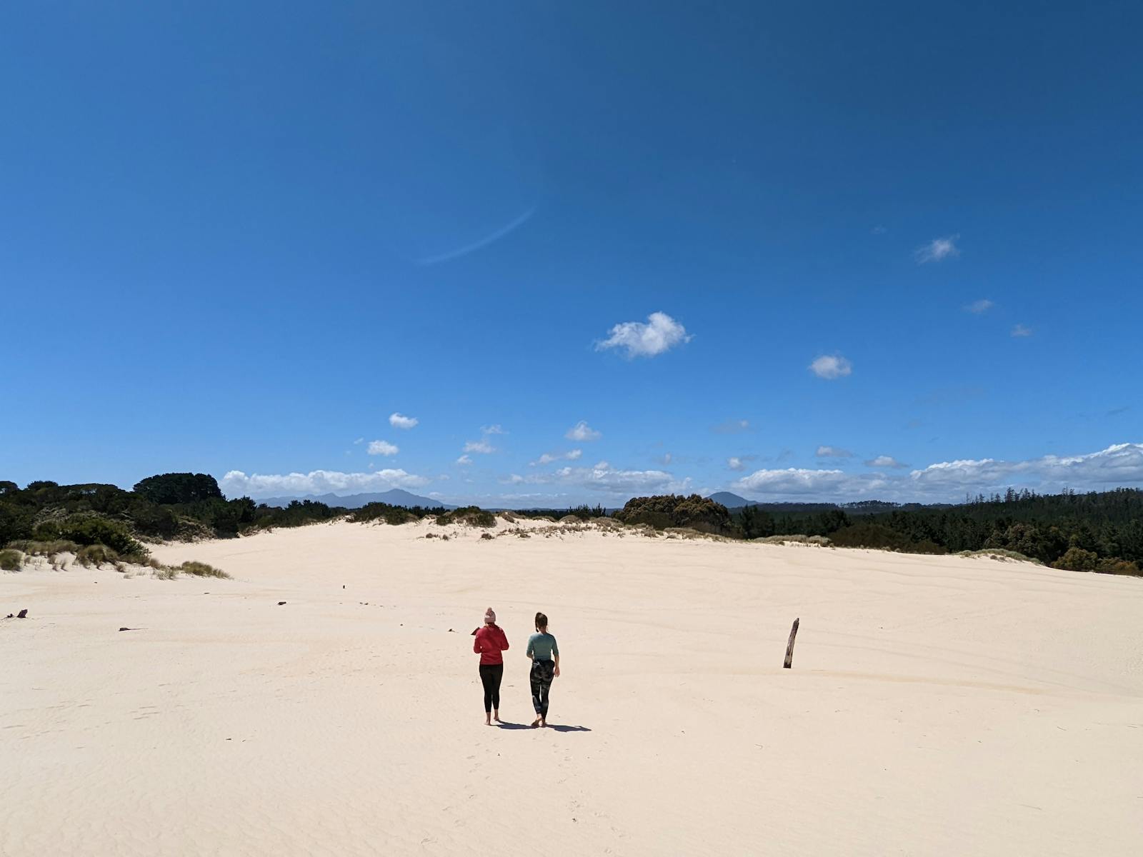 Two guests walk along Henty Sand Dunes