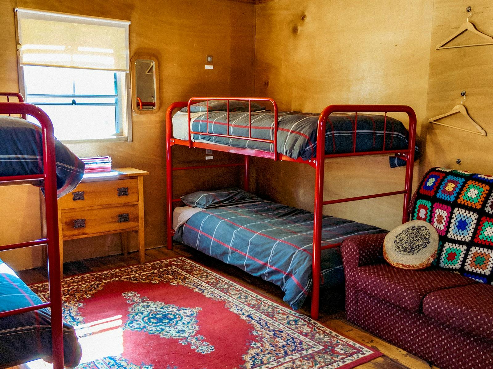2 double-decker single bunk beds and a small sofa beds